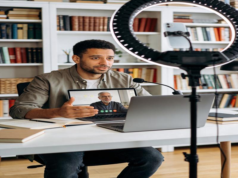 A tutor giving warm feedback to an adult student in a professional online setting